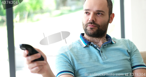 Image of Happy Man Watching Television