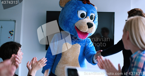 Image of boss dresed as bear having fun with business people in trendy of