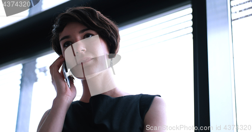 Image of Business Girl Standing In A Modern Building Near The Window With