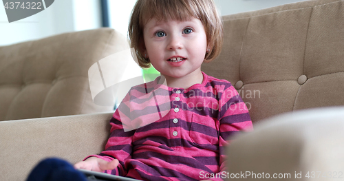 Image of Child using tablet in modern apartment