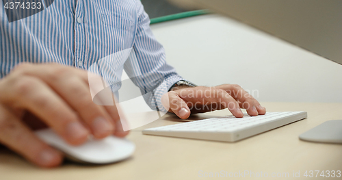 Image of hands typing on computer keyboard in startup office