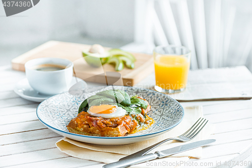 Image of Scrambled eggs on meat with fried potatoes and toast