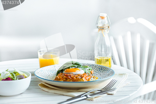 Image of Scrambled eggs on meat with fried potatoes and toast