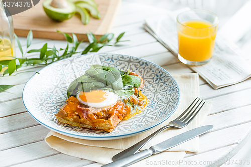 Image of Scrambled eggs on meat with fried potatoes and toast