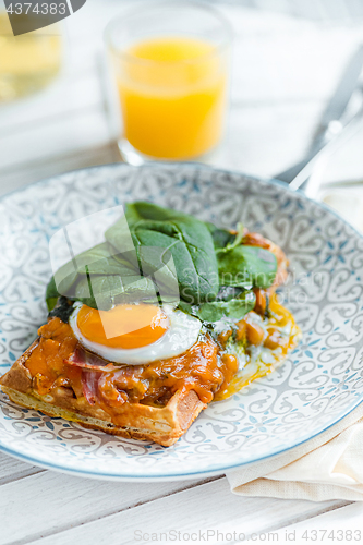 Image of Scrambled eggs on meat with fried potatoes and toast