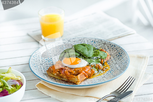 Image of Scrambled eggs on meat with fried potatoes and toast