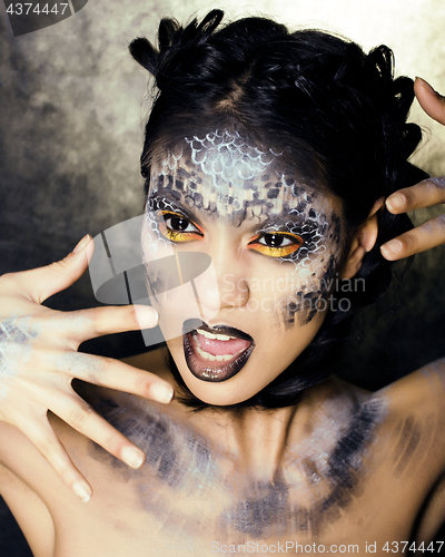 Image of fashion portrait of pretty young woman with creative make up like a snake