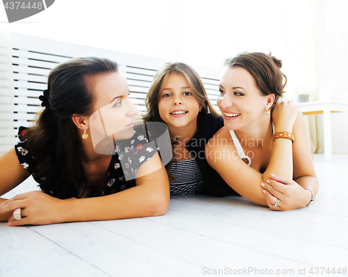 Image of Mature sisters twins at home with little daughter, happy family