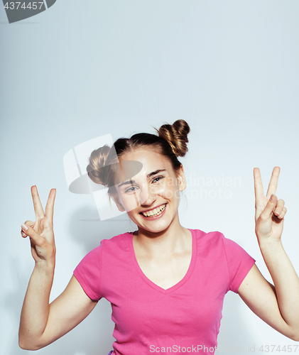 Image of young pretty teenage hipster girl posing emotional happy smiling on white background, lifestyle people concept 