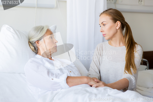 Image of daughter visiting her senior mother at hospital