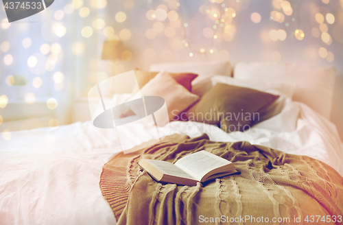 Image of bedroom with bed and christmas garland at home