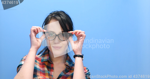 Image of woman smiling wearing on a pair of large glasses