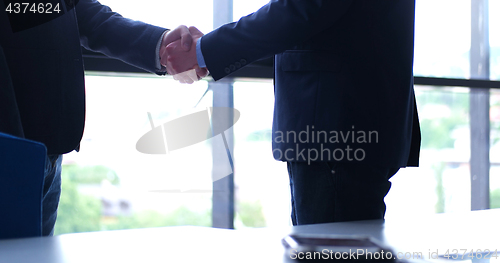 Image of cloasing the deal in modern office interior