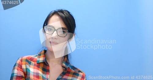 Image of woman smiling wearing on a pair of large glasses