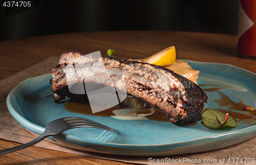 Image of grilled pork ribs on dark plate