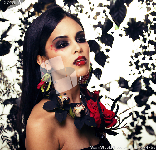 Image of pretty brunette woman with rose jewelry, black and red, bright m