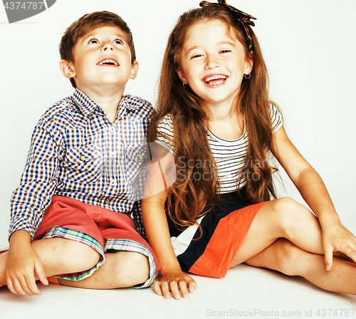 Image of little cute boy and girl hugging playing on white background, ha