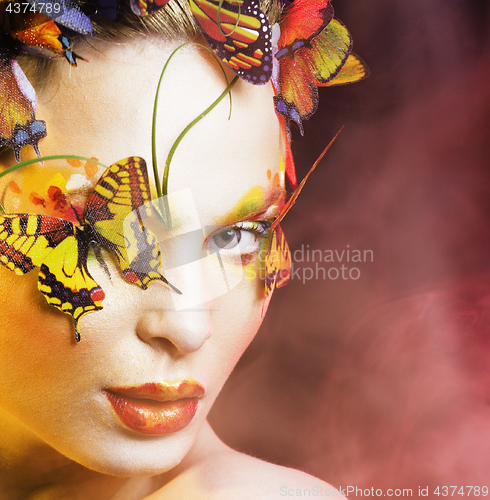 Image of woman with summer creative make up like fairy butterfly closeup 