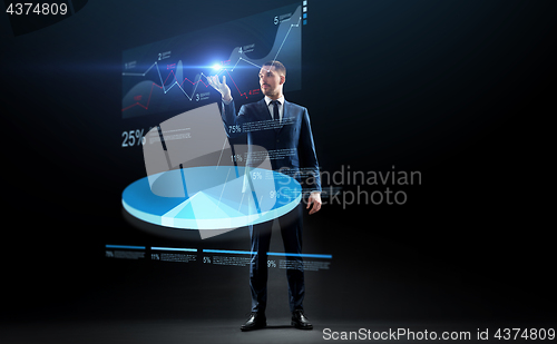 Image of businessman in suit working with virtual pie chart