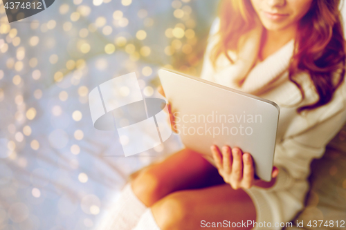 Image of young woman with tablet pc in bed at home