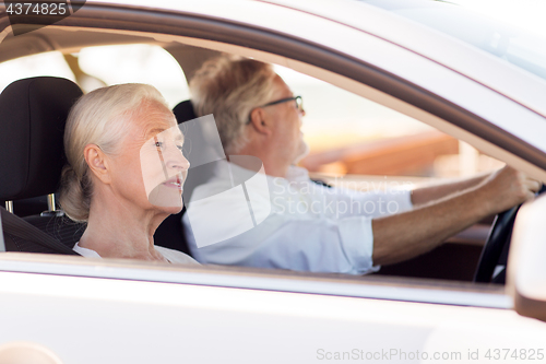 Image of happy senior couple driving in car