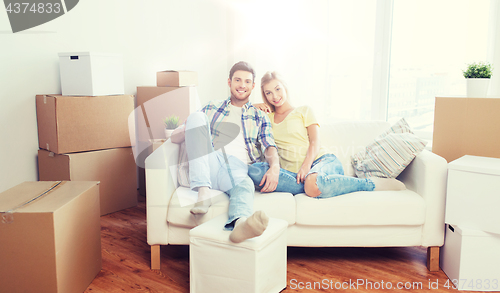 Image of happy couple with big cardboard boxes at new home