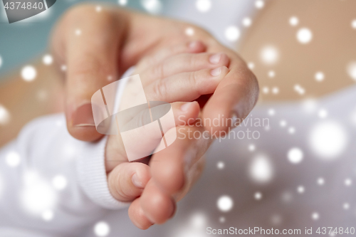 Image of close up of mother and newborn baby hands