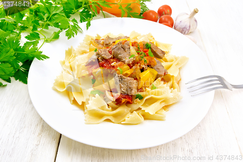 Image of Farfalle with turkey and vegetables in sauce on table