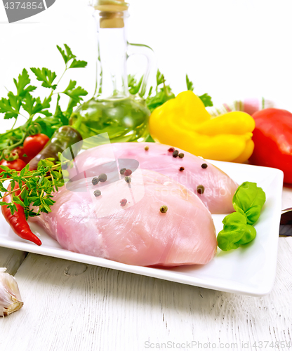 Image of Chicken breast raw in plate on board