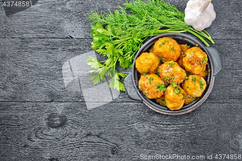 Image of Meatballs in brazier on black board top