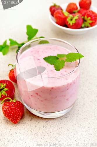 Image of Milkshake strawberry with berries on granite table