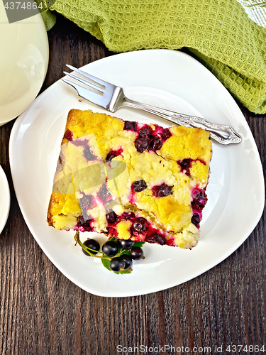 Image of Pie with black currant in plate on board top