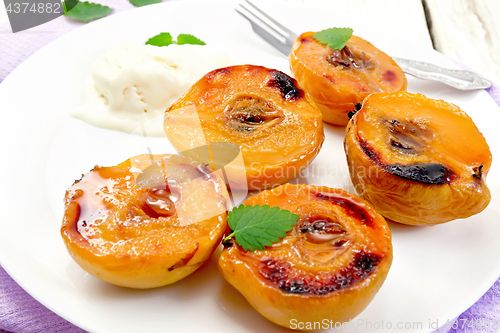 Image of Quince baked with ice-cream in plate on lilac napkin