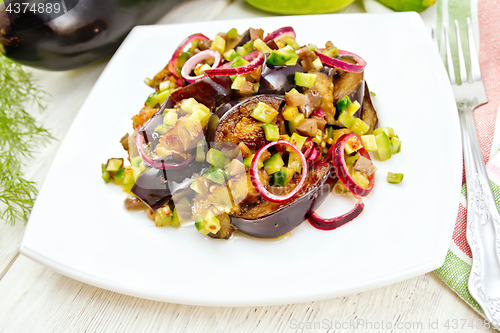 Image of Salad from eggplant and cucumber in plate on light board