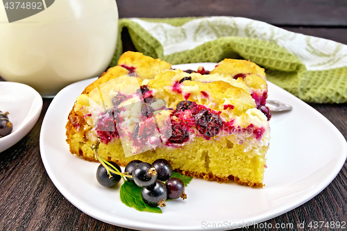 Image of Pie with black currant in plate on dark board