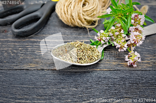 Image of Thyme dry in spoon with twine on black board