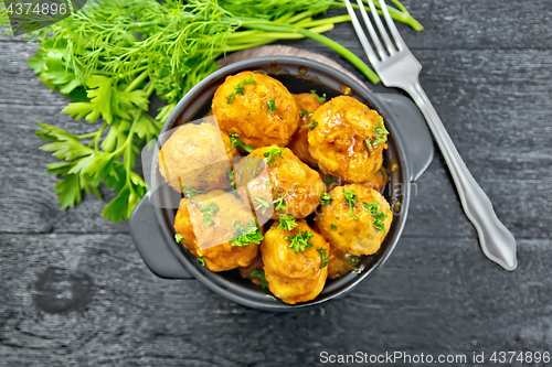 Image of Meatballs in brazier with greens on board top