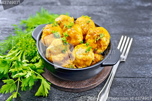 Image of Meatballs in brazier on black board