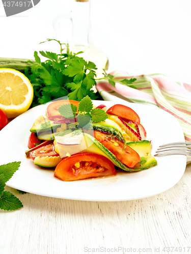 Image of Salad with zucchini and tomato on board