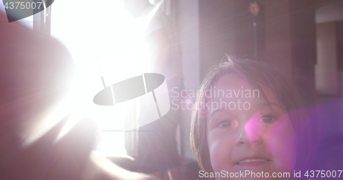 Image of Mother And Daughter Using A Tablet at home on sofa