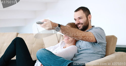 Image of senoior couple watching tv in modern villa