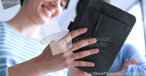 Image of low angle shot of business people using technology