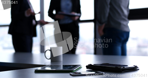 Image of tablet, mobile cell phone and cup of coffee  in office with busi