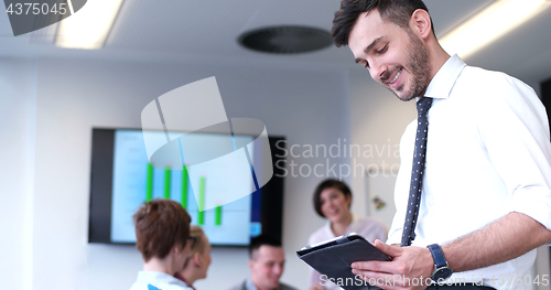 Image of Businessman using tablet in modern office