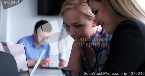 Image of group of business people having a meeting in bright office