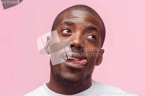 Image of Positive thinking African-American man on pink background