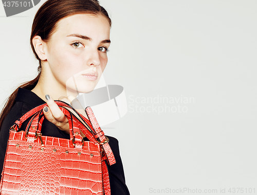 Image of young pretty cool fashion business lady wearing black suit and orange little bag smiling on white background, lifestyle people concept 