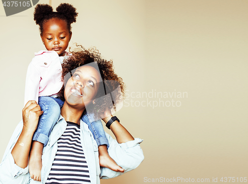 Image of adorable sweet young afro-american mother with cute little daughter, hanging at home, having fun playing smiling, lifestyle people concept 