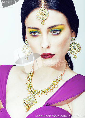 Image of young pretty caucasian woman like indian in ethnic jewelry close up on white, bridal bright makeup fashion people