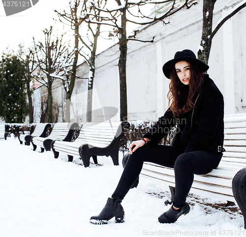 Image of young pretty teenage hipster girl outdoor in winter snow park having fun drinking coffee, warming up happy smiling, lifestyle people concept